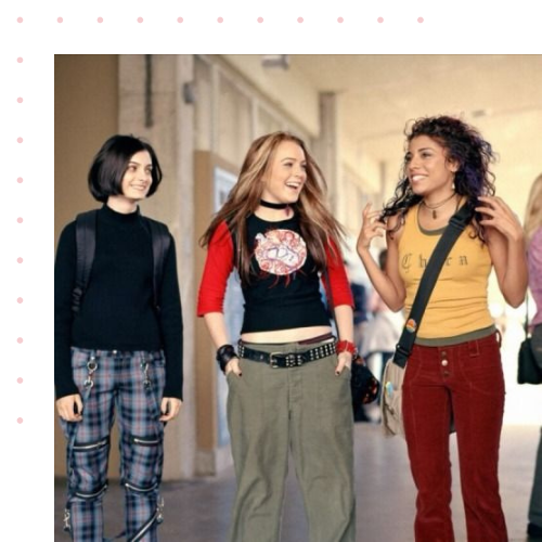 Three teenagers dressed very differently walking together in a high school